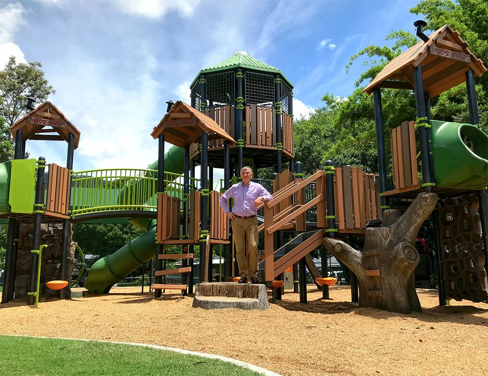 Man standing in front of playground.